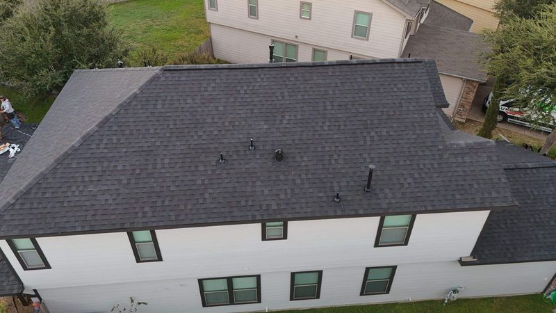 New charcoal shingle roof on a two-story home in Cypress, TX