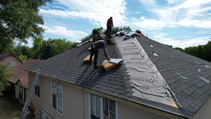 PL Roofing crew installing shingles on a two-story home