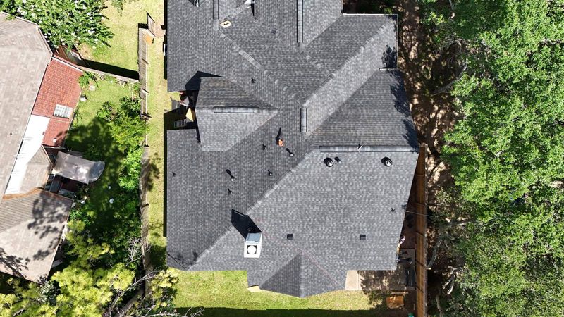 Aerial view of a new charcoal shingle roof in Sugar Land, TX