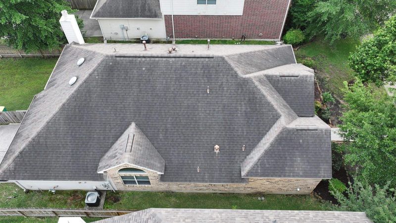 Aerial view of a shingle roof on a home in The Woodlands, TX, photographed by PL Roofing