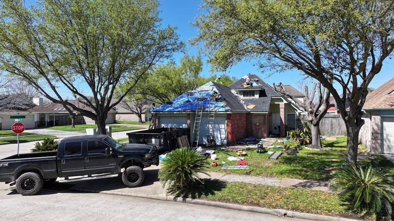 PL Roofing crew and dumpster at a roof replacement in the Houston area