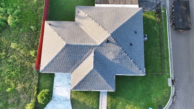 Straight-down drone photo of a gray shingle roof on E 31st St in Houston showing every slope, hip and vent at once