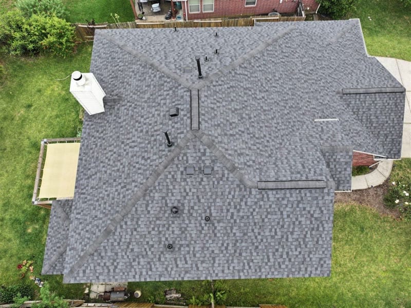 Homeowner and PL Roofing reviewing inspection findings beside a completed asphalt shingle roof in Spring, TX