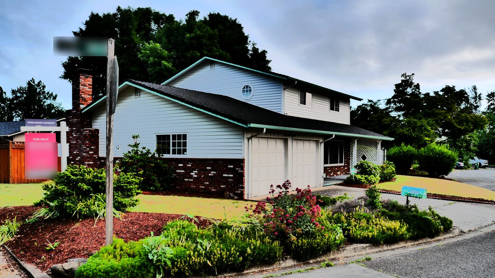 Two-story house with a For Sale sign in the front yard and a dark asphalt shingle roof