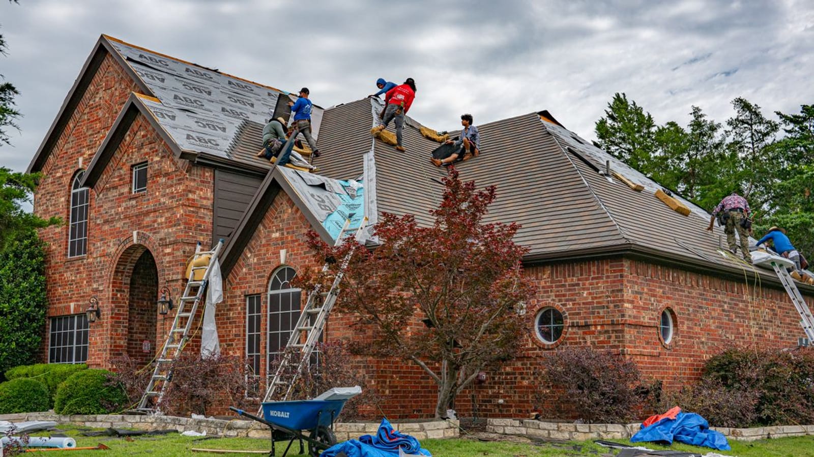 A PL Roofing & Remodeling crew mid-replacement on a Houston-area home