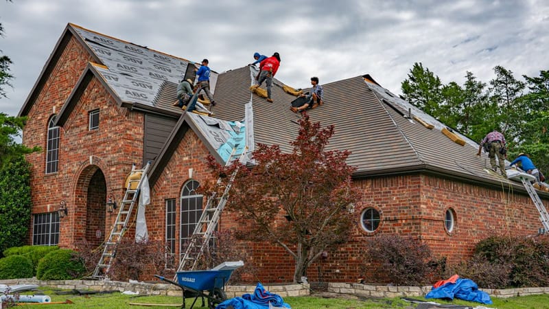 PL Roofing crew replacing an asphalt shingle roof on a Texas home