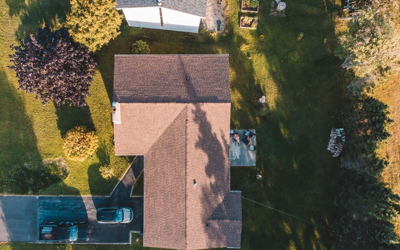 Aerial drone view of an asphalt shingle roof on a suburban home for documentation